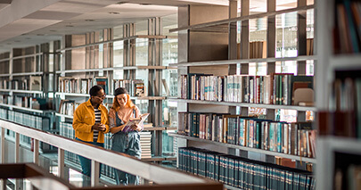 two students in the library studying