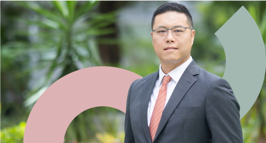 Headshot of Laurence Ho, in a suit, face to camera