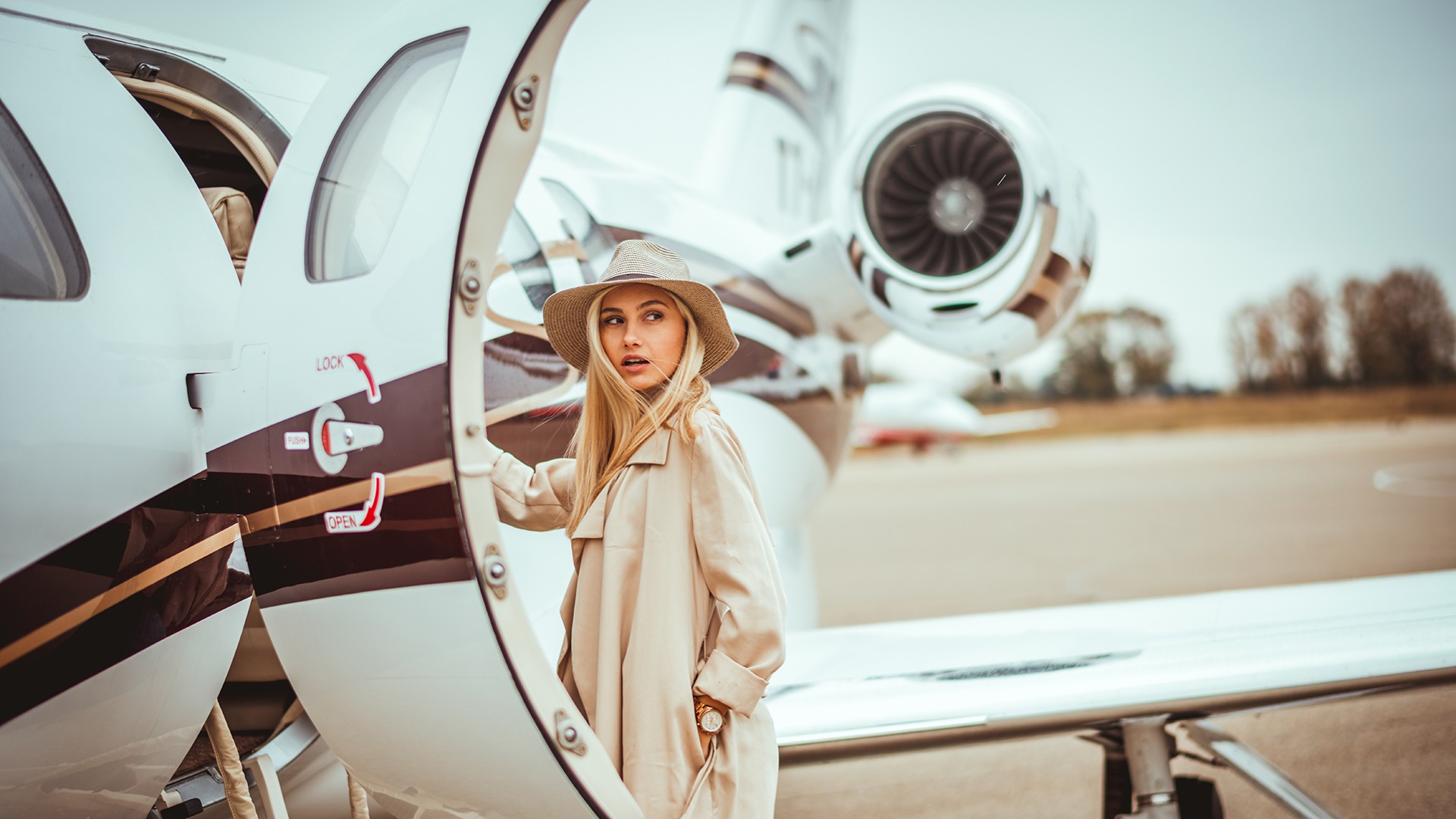 Young rich woman about to enter private jet