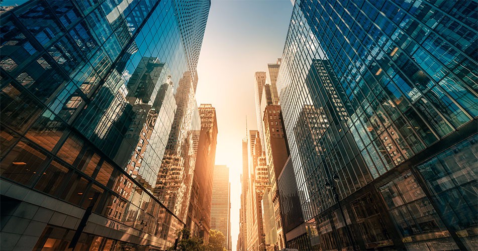 Picture of sun blaring down a glassed buildings