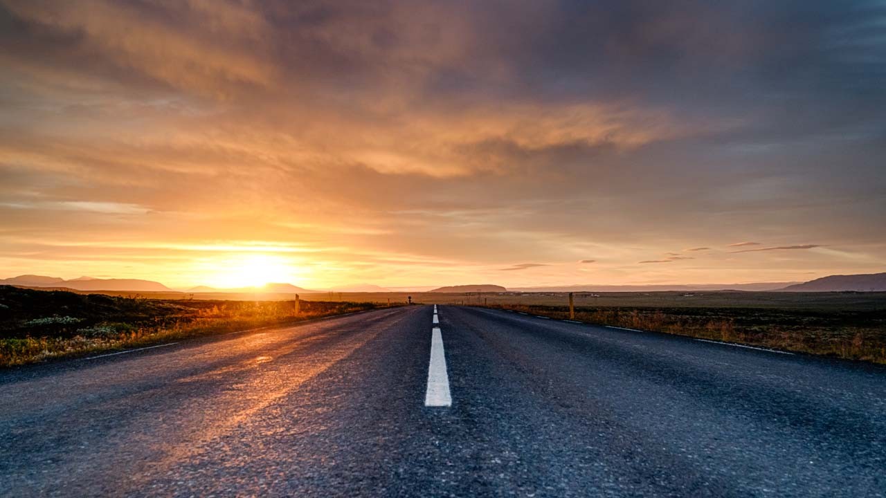 Picture of a road leading into a sunset 