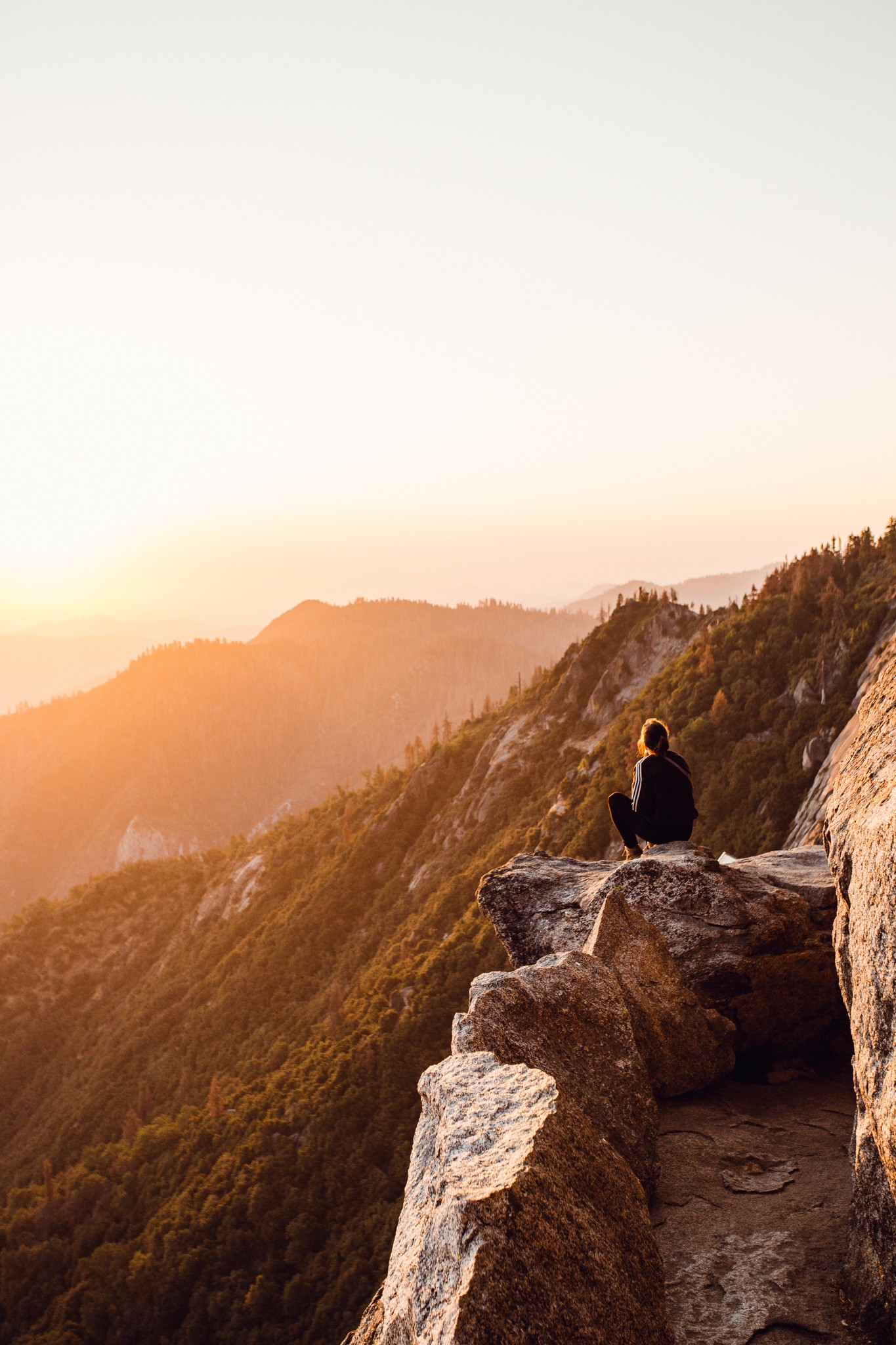 Picture of a woman sitting on a cliff edge
