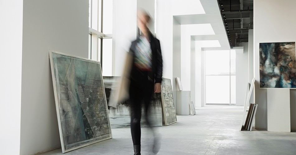 Picture of a woman walking past art work