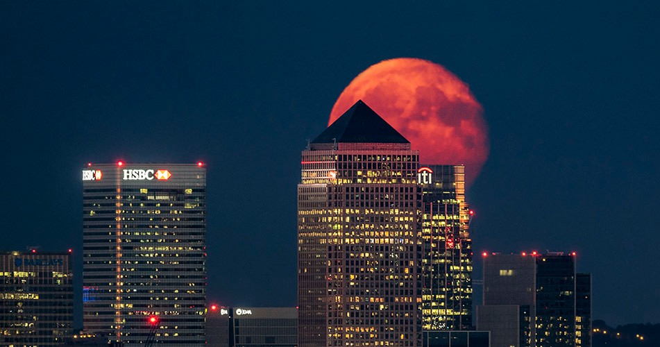 Picture of a blood moon behind skyscrapers