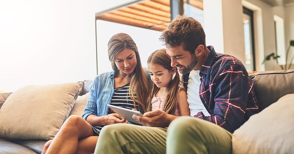 Picture of a family looking at an electronic tablet