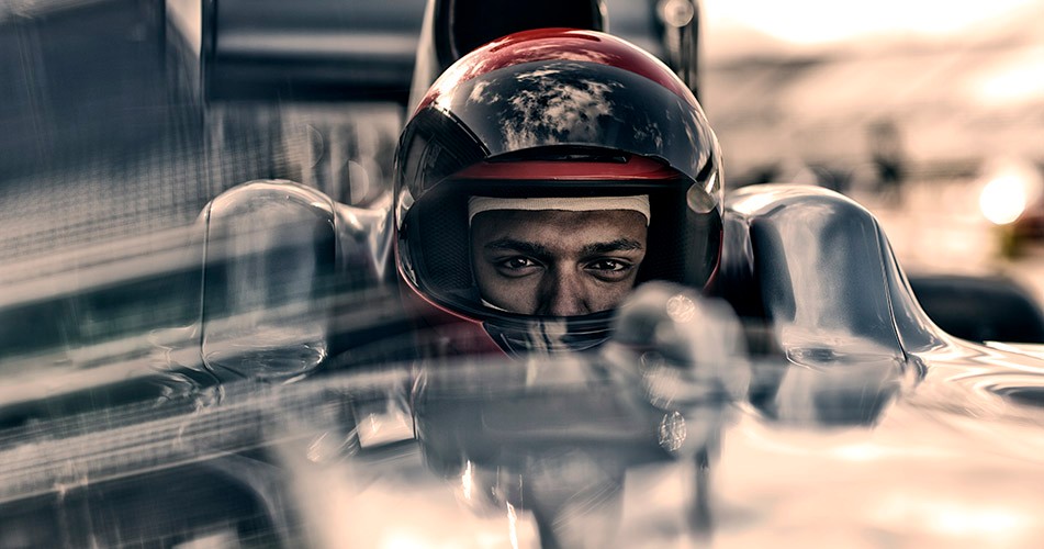 F1 driver sitting in racing car
