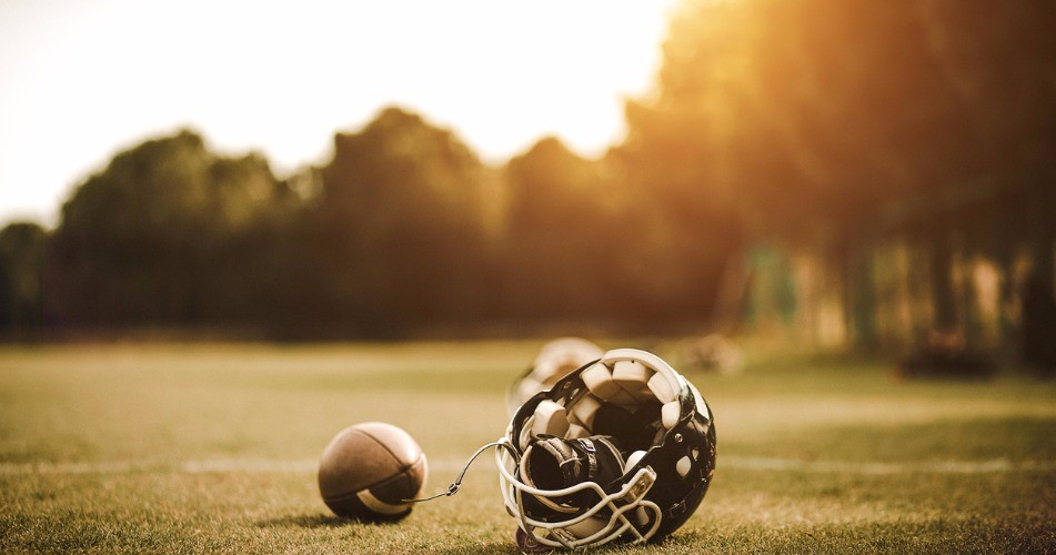 Picture of an American football helmet on a field