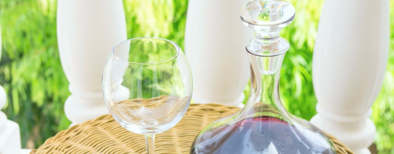 Picture of a wine glass and a bottle beside