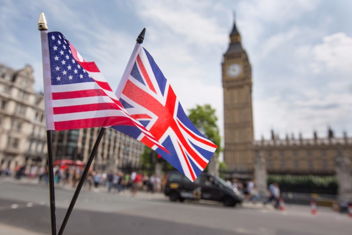 Picture of an American and United Kingdom flag in front of big ben
