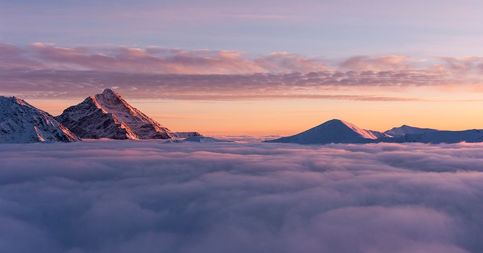 Picture of a mountain above clouds