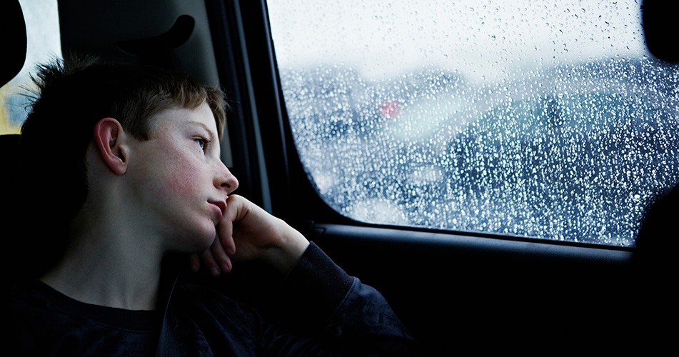 Picture of a child looking out of a car window