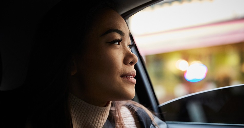 Picture of a woman looking out of a car window