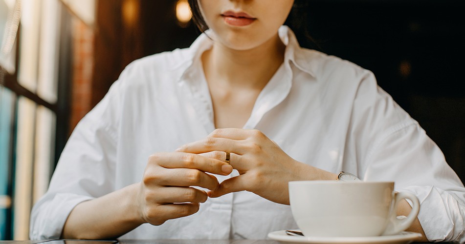Picture of a woman removing a wedding band