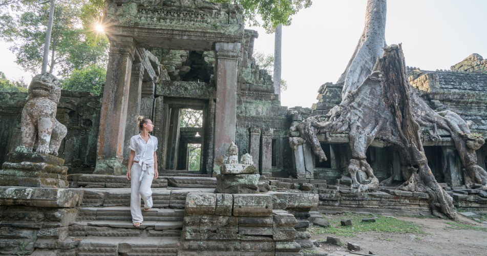 Picture of young woman wandering in ancient temple exploring old ruins