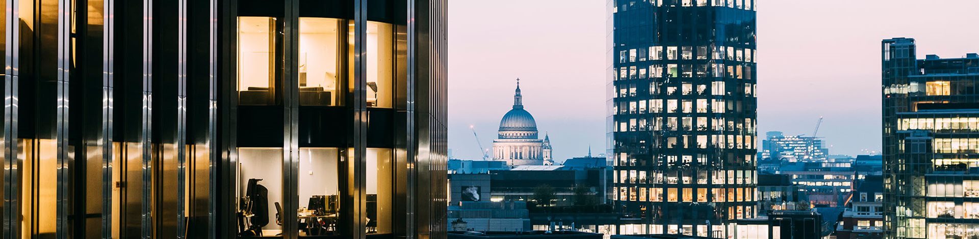 Close-up of office building with London skyline in the background
