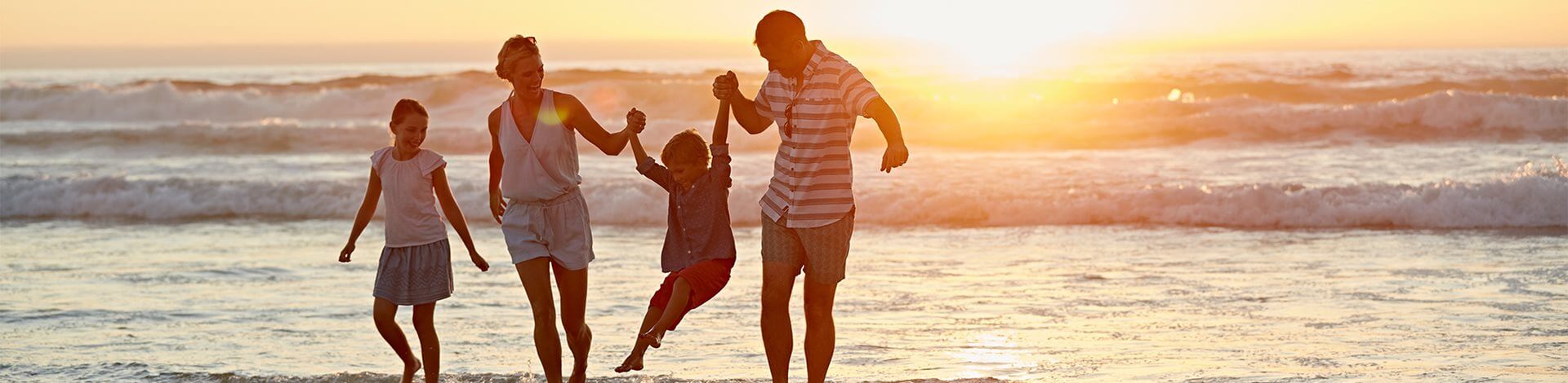 Family walking up a beach