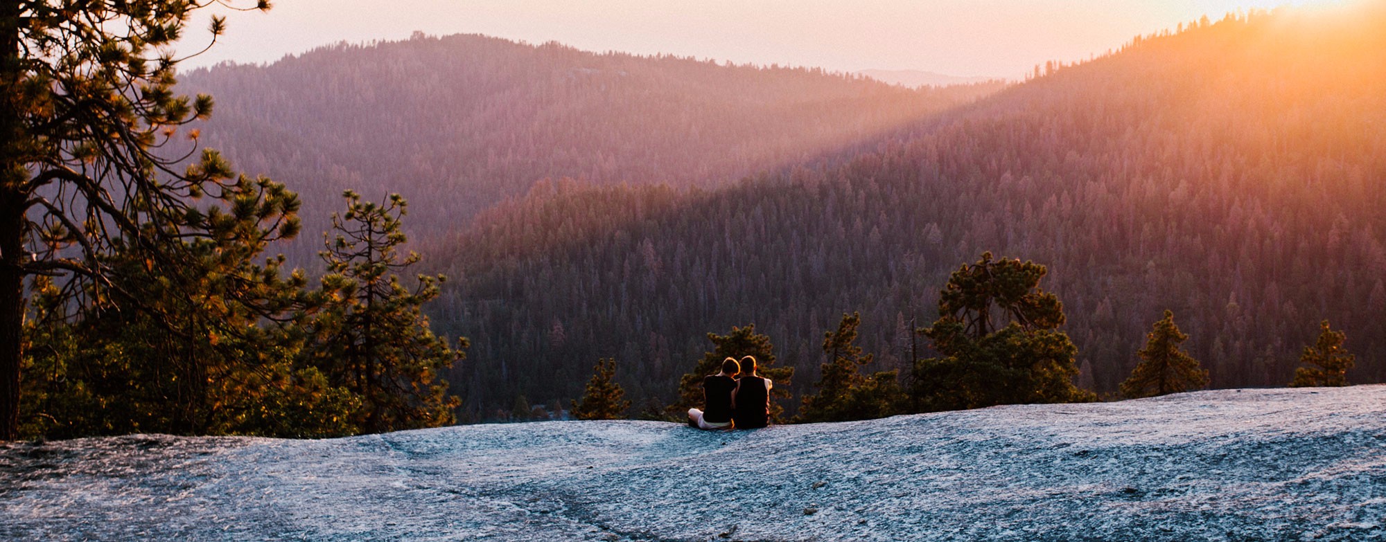 Couple looking over hills in forest