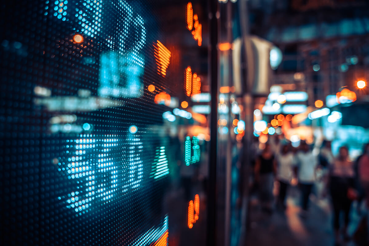 stock market numbers with blurred people in the background