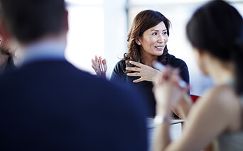 Lady speaking in boardroom meeting