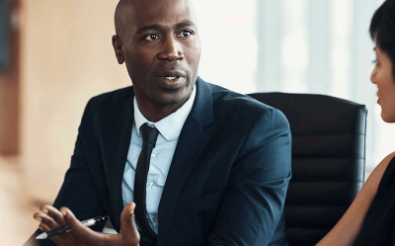 Man talking to lady in business meeting