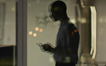 Man looking down at phone