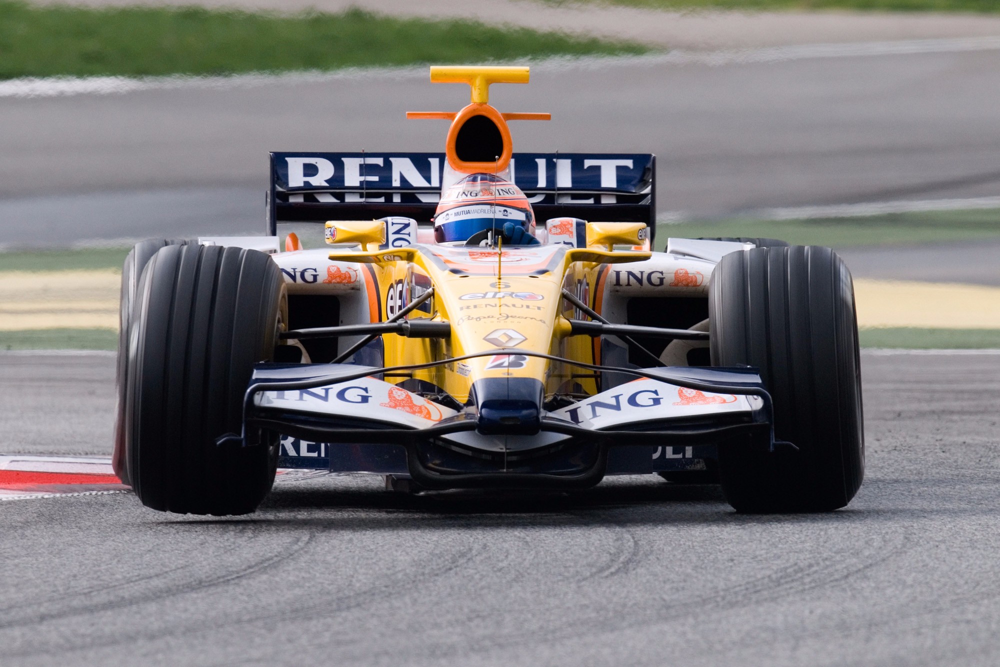 Sponsored race car being driven on racetrack