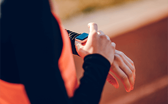 Athlete checking fitness tracker on wrist 
