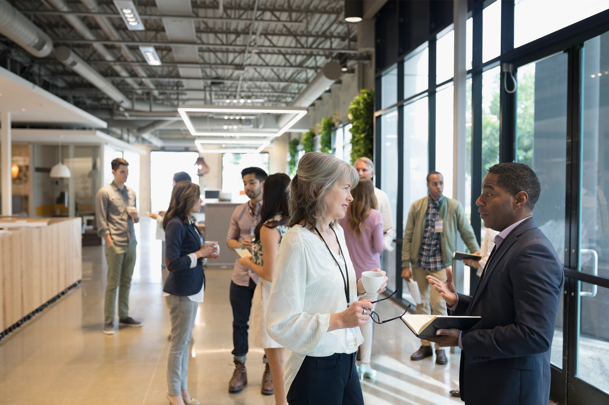 Groups of people having conversations in an office