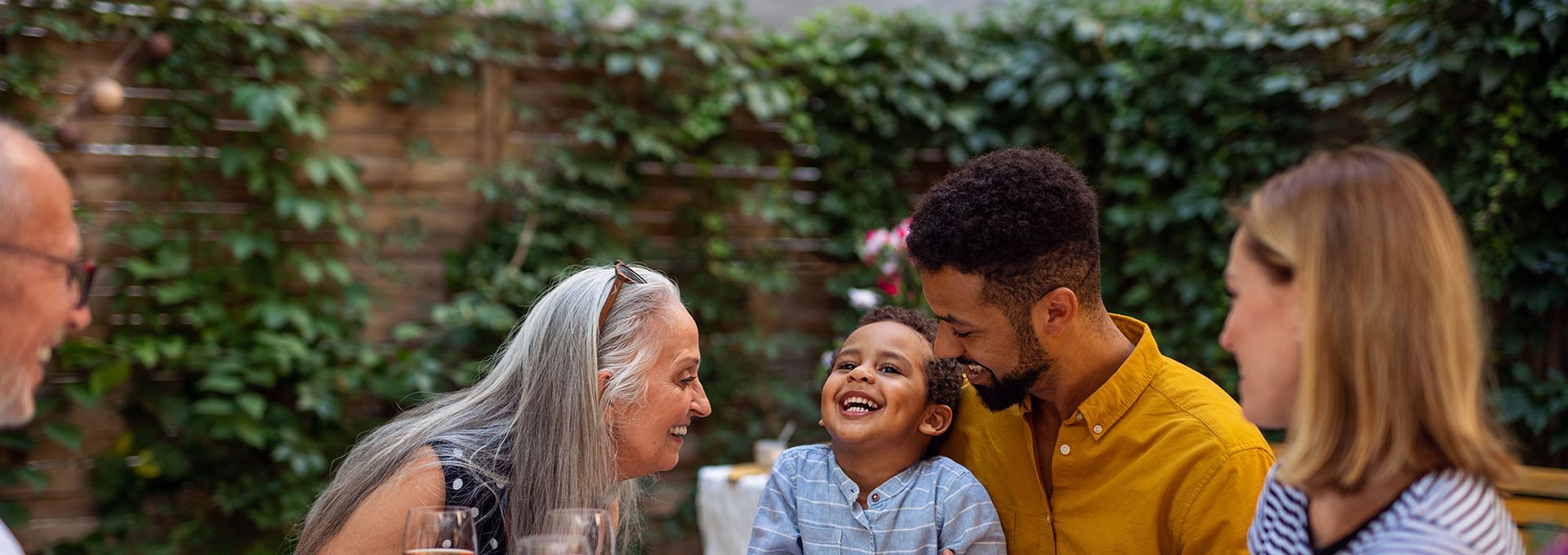 Family of three generations having dinner together outside