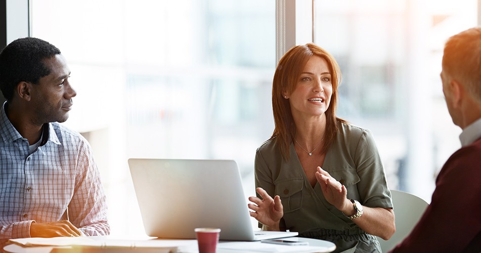 Woman explaining a mediation to two men
