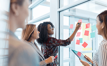Group meeting looking at post it notes