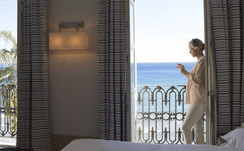 Woman standing on balcony of luxury hotel