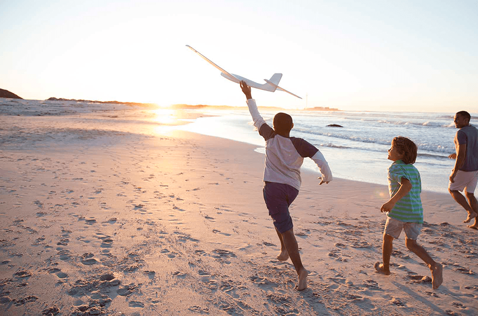 Family running on beach