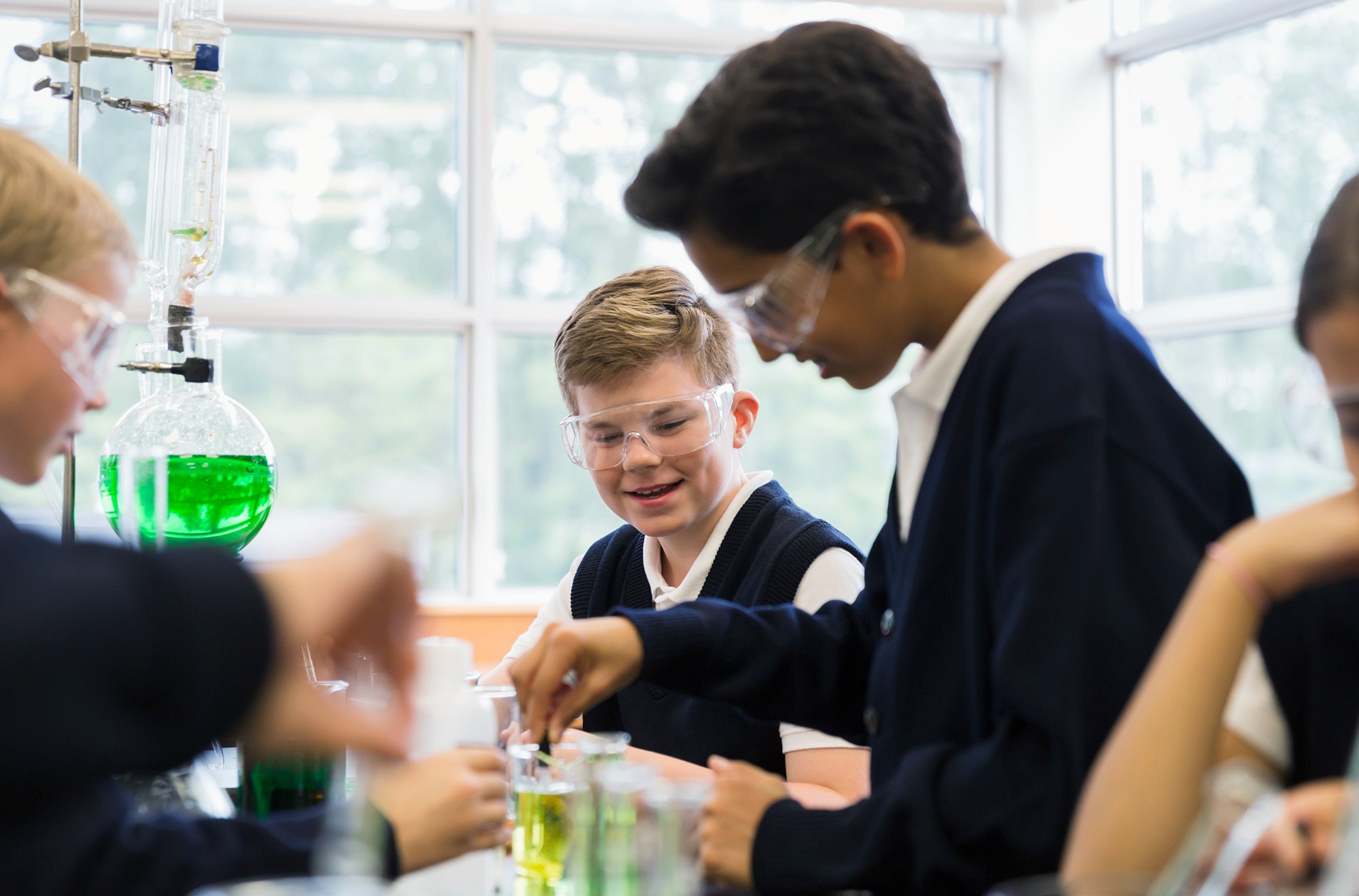 Young students experimenting with chemicals in chemistry lab