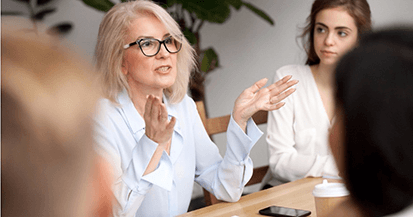 Woman speaking to group of people in business meeting