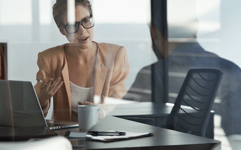 Woman talking to man in business meeting