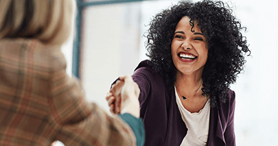 Two women shaking hands