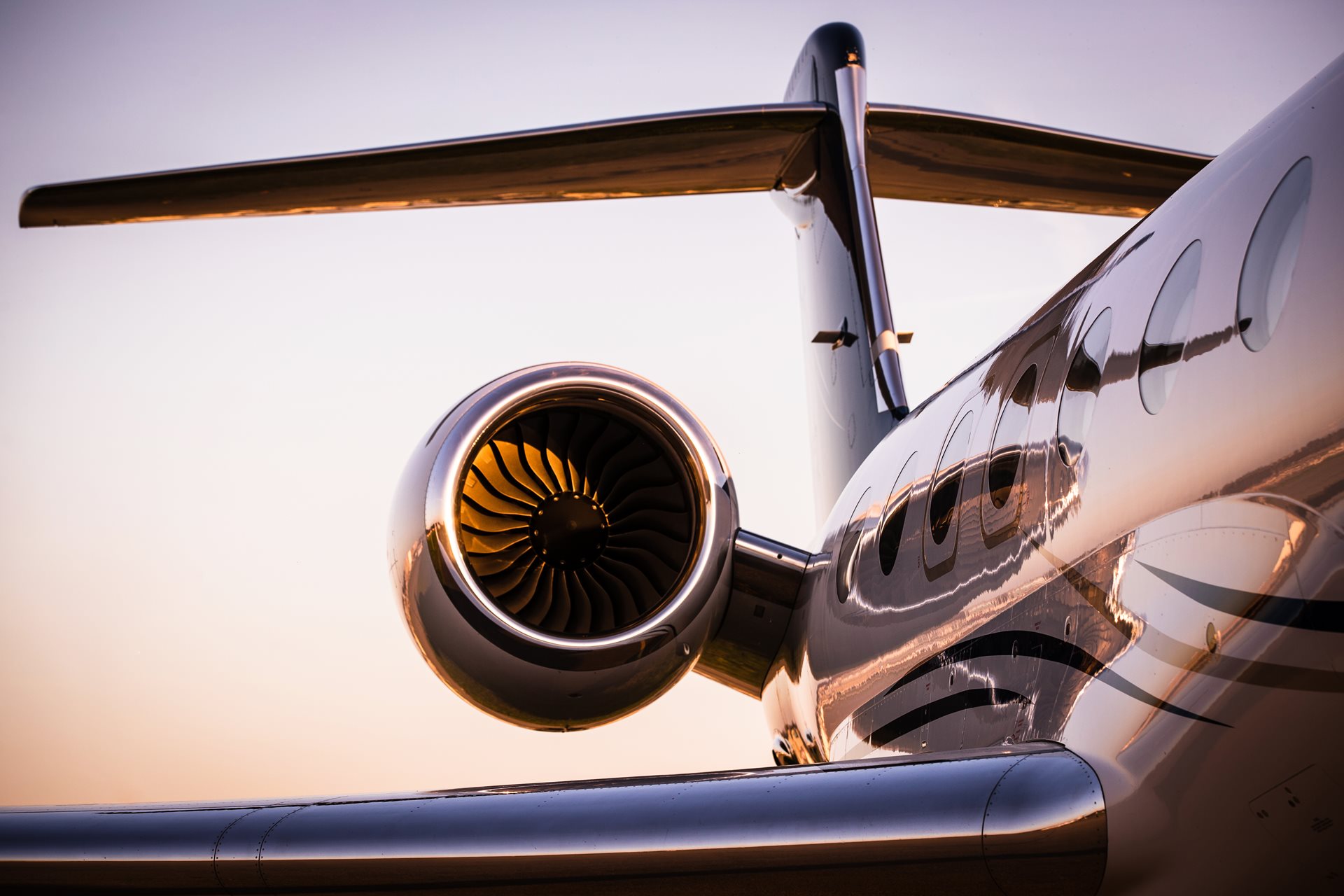 Side of corporate jet during sunset