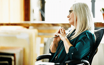 Woman sitting in chair at business meeting