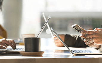 People typing on laptops and phones