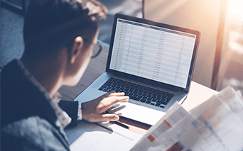 Man analysing numerical data on computer