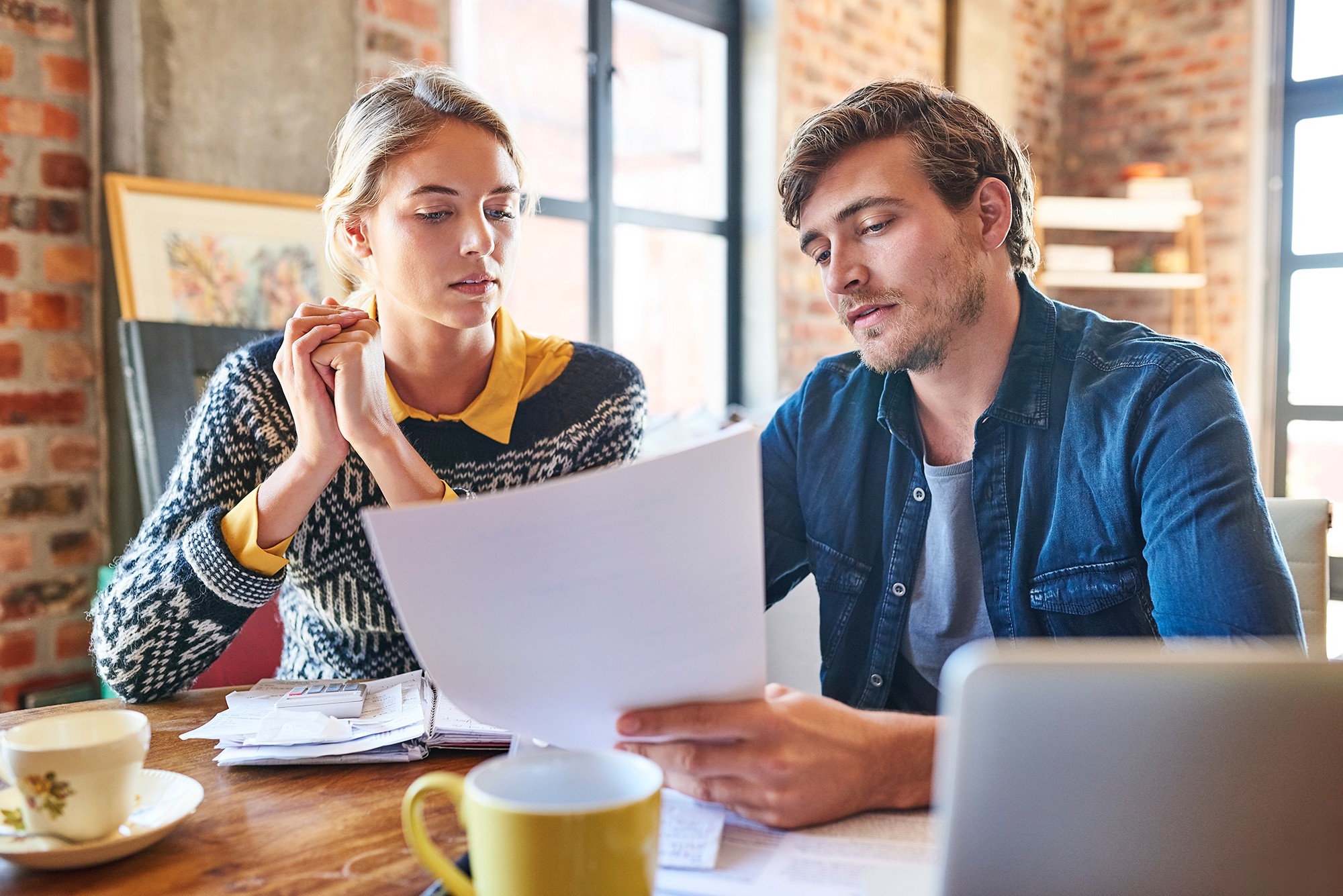 Couple sitting around table studying documents