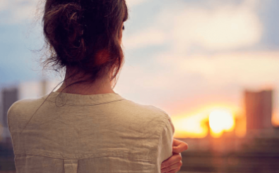 Woman staring at sunset 